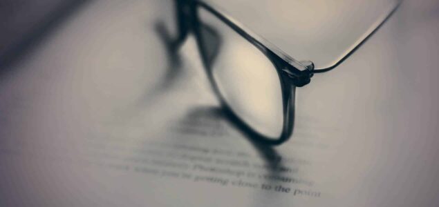 close up reading glasses on a book